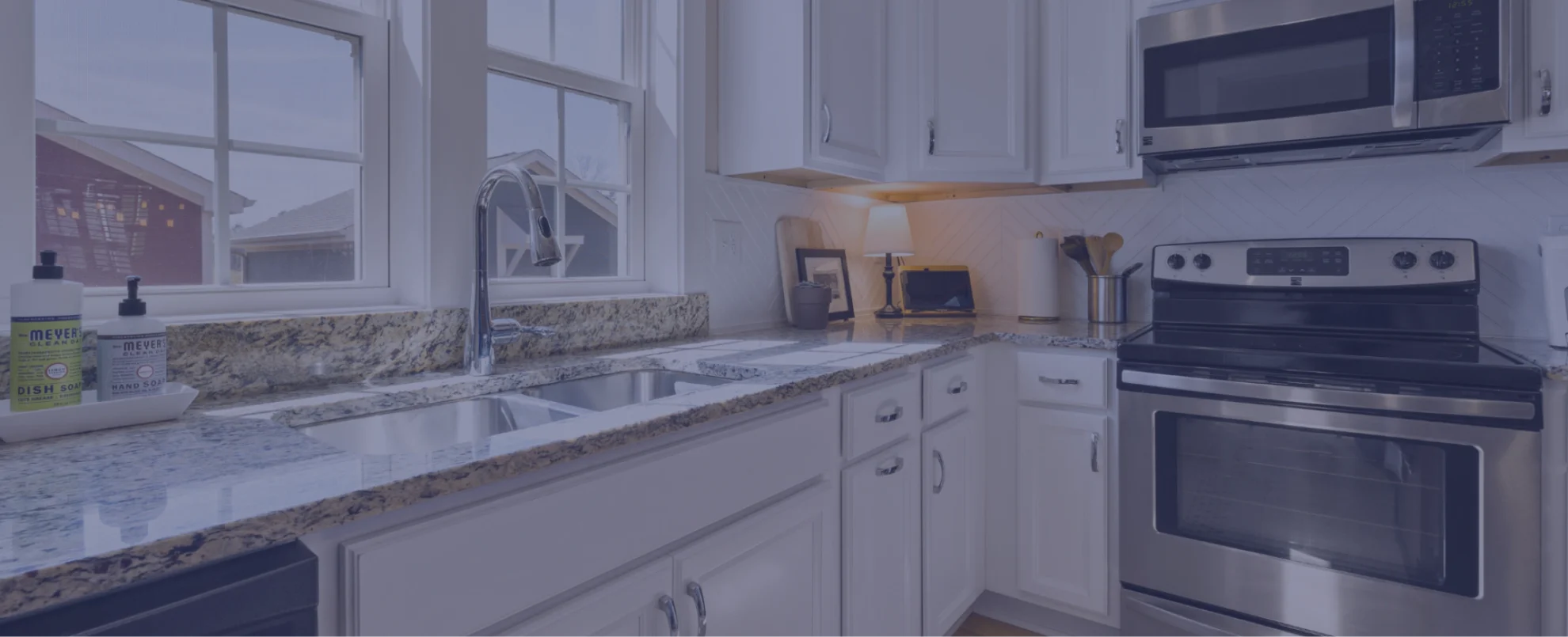 kitchen with marble counter and silver oven and microwave